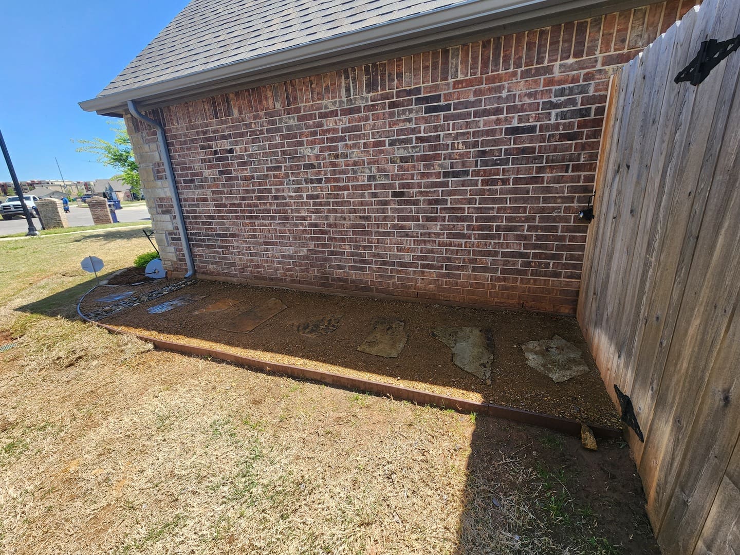 Backyard landscape grading and preparation for installation in Oklahoma