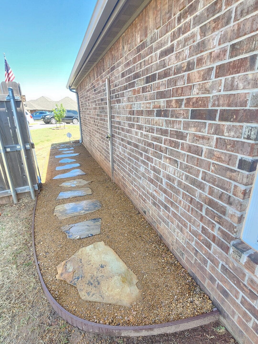 Flagstone stepping stone walkway installation beside home in Oklahoma