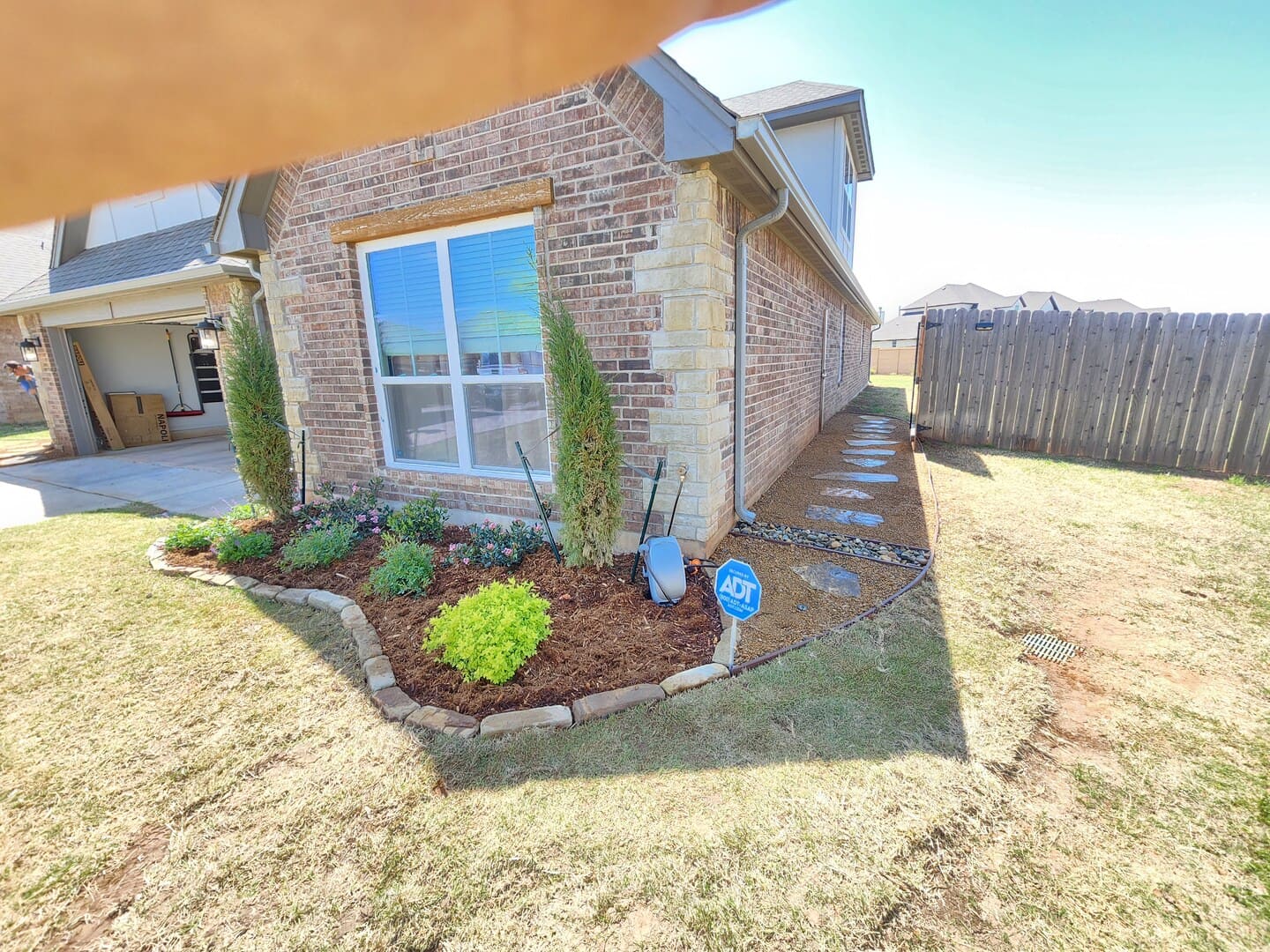 Front yard landscape design with shrubs and mulch beds in Oklahoma