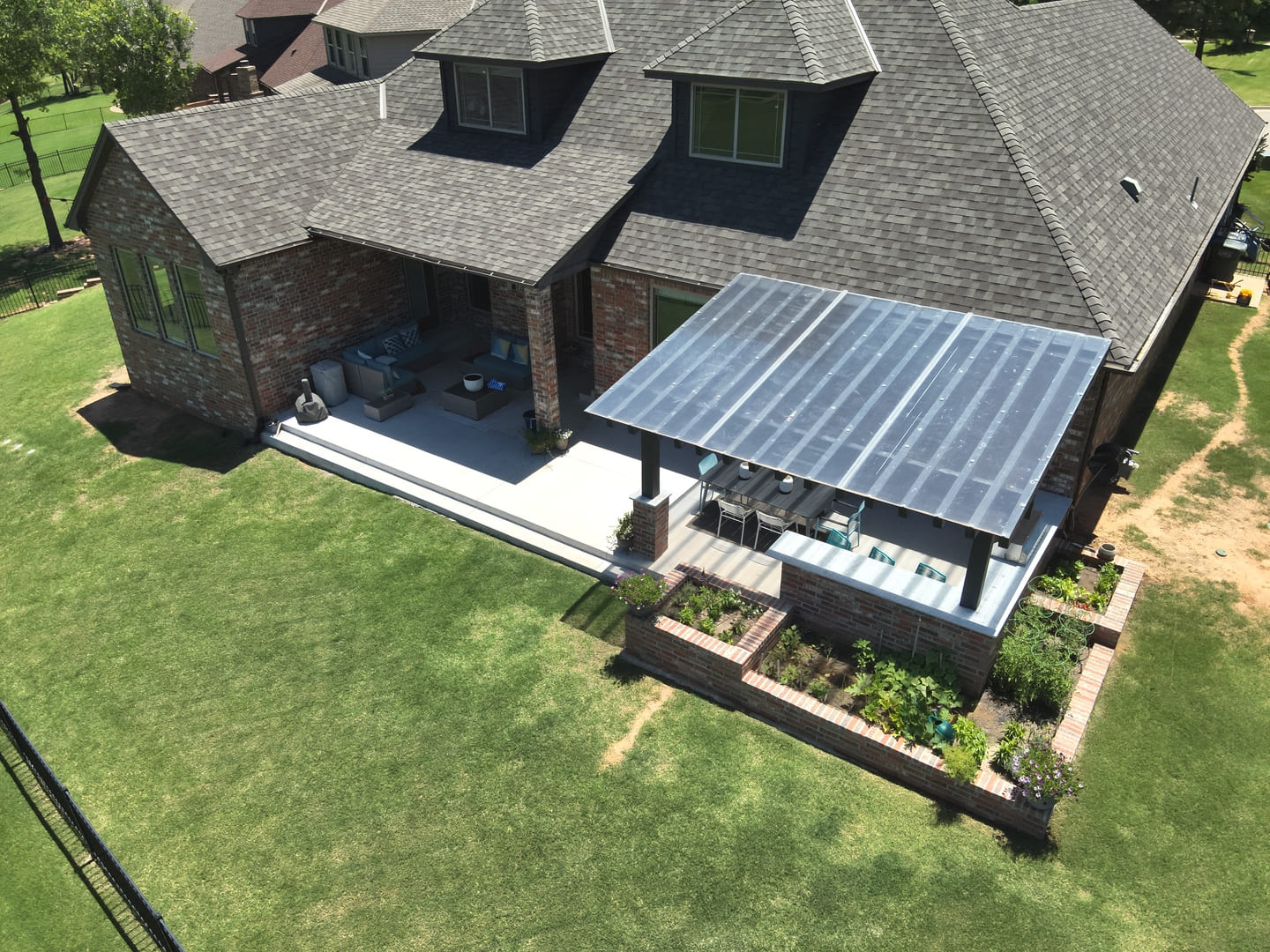 Backyard pergola and patio landscape installation in Oklahoma
