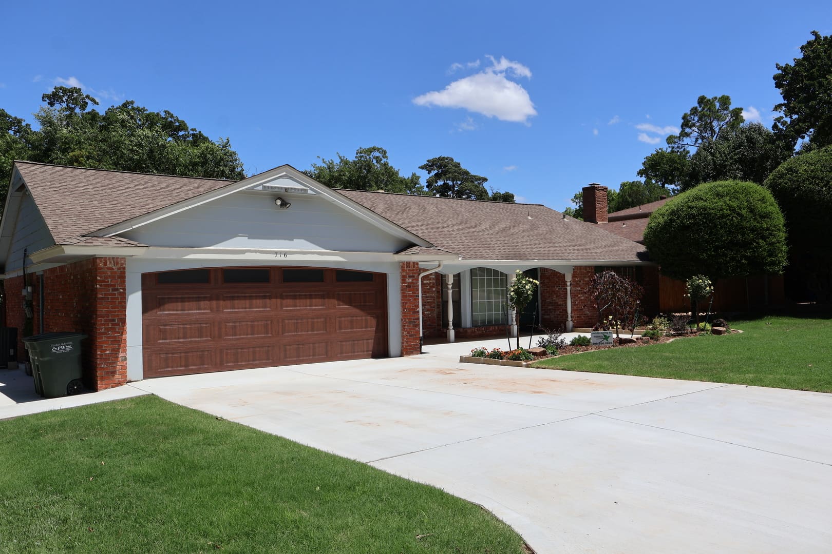 Residential driveway and lawn landscape installation in Oklahoma