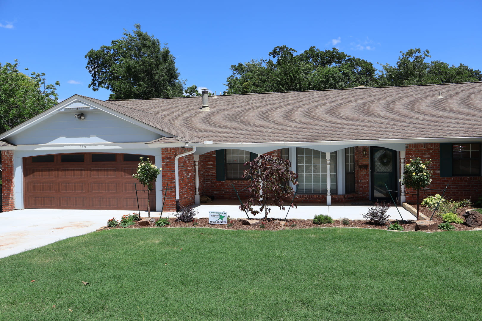 Front yard landscape installation with curved planting beds in Oklahoma