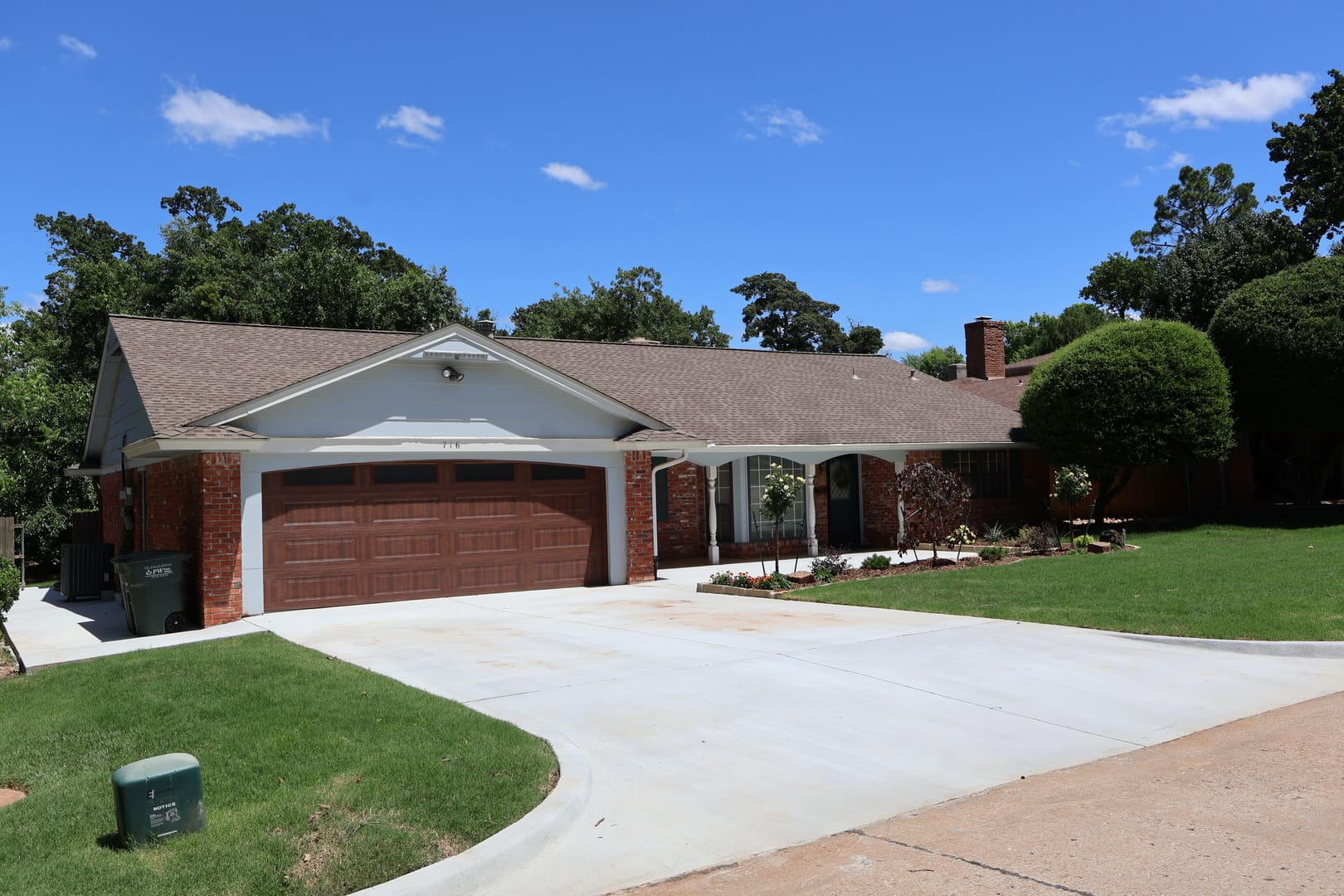 Residential driveway and front yard landscape installation in Oklahoma