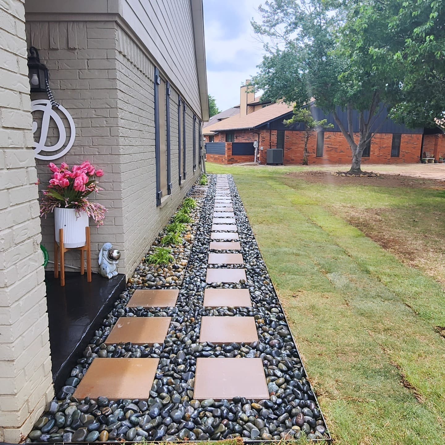 Decorative stepping stone walkway with rock border installation in Oklahoma