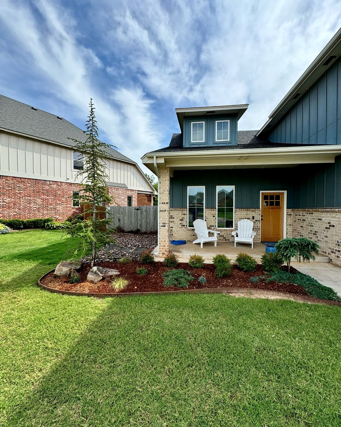 Front yard landscape installation with curved flower beds in Oklahoma