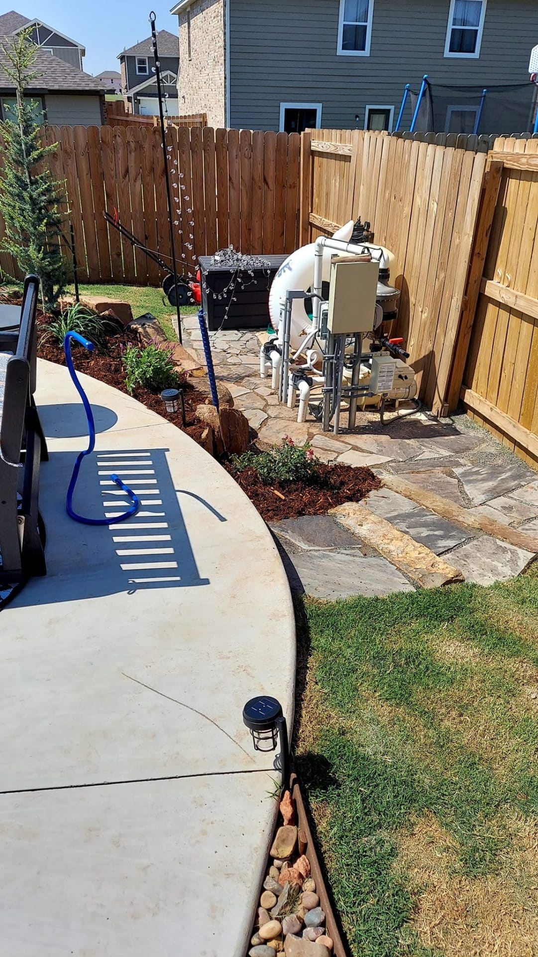 Flagstone patio installation beside backyard pool in Oklahoma