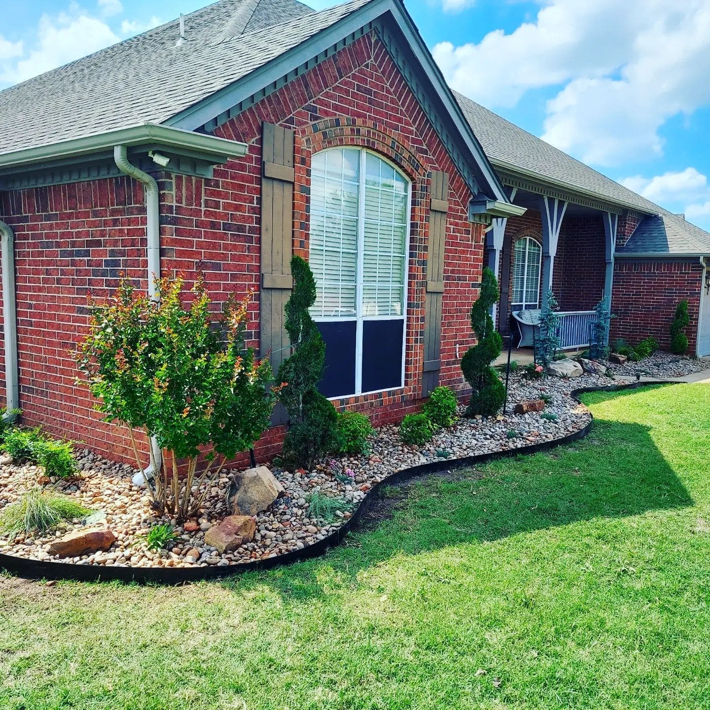 Front yard landscape installation with rock border flower beds in Oklahoma